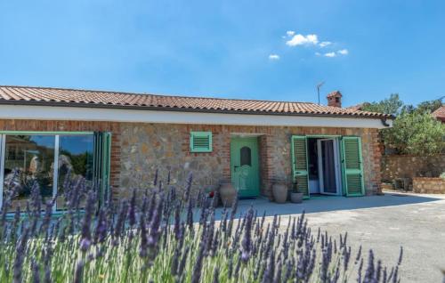a stone house with purple flowers in front of it at House Victoria 2 by Villas Guide in Nerezine