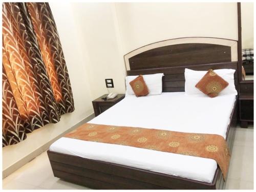 a bedroom with a bed in a room with a poster at HOTEL G!S Paradise Amritsar - Provided Fully Air Conditioned & Well Decorated Rooms - Free Parking And Free Wi-fi Facility - A Premium Hotel In Amritsar in Amritsar