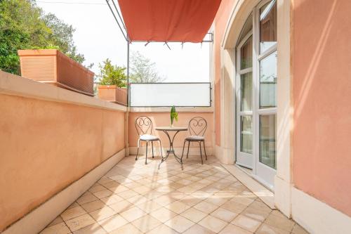 a small balcony with a table and chairs on it at Relais Villa San Martino in Martina Franca