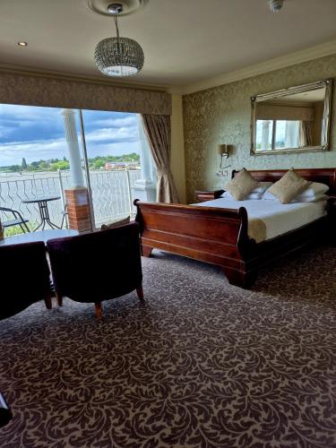 a hotel room with two beds and a large window at Wherry Hotel in Lowestoft