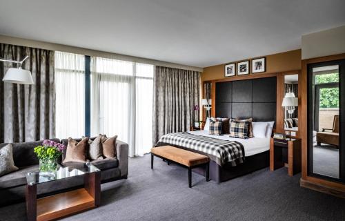 a hotel room with a bed and a couch at Norton House Hotel & Spa, Edinburgh in Ingliston