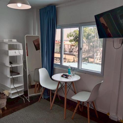 a room with a table and two chairs and a window at Aran hostel Spa&Cafe Riverside That Phanom in Amphoe That Phanom