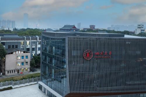 a tall building with a sign on the side of it at Atour Hotel Chengdu Sichuan University North Kehua Road in Chengdu