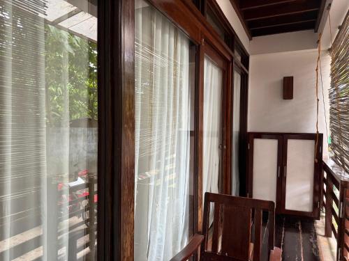 a room with a window with blinds on it at Bayay ni Mamang Siargao - Ground Level in General Luna