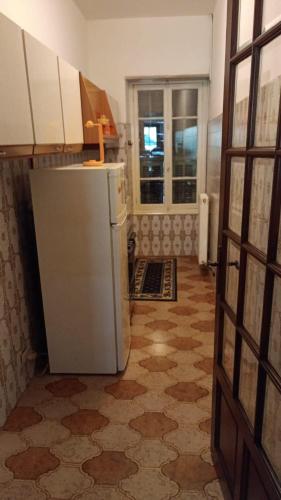 a kitchen with a refrigerator in a room at La casa di Jacky in Apricale