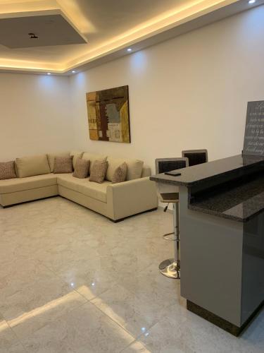 a living room with a couch and a table at Executive Apartments in Amman
