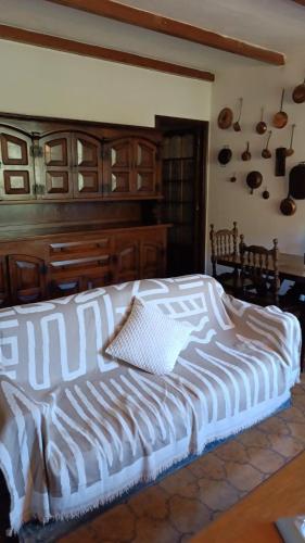 a bedroom with a white bed with a wooden headboard at La casa di Jacky in Apricale