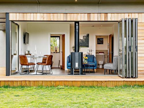 a sliding glass door opens up to a living room and dining room at 2 Bed in East Bergholt 82399 in East Bergholt