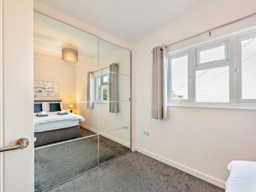 a bathroom with a glass door leading to a bedroom at 2 Bed in Aberaeron 94044 in Henfynyw Upper