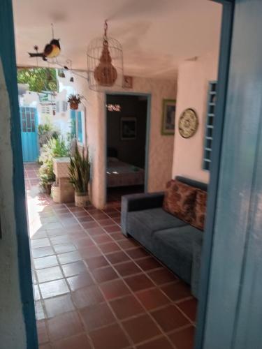 a living room with a couch and a clock on the wall at Hostal ROLLED in Villavieja