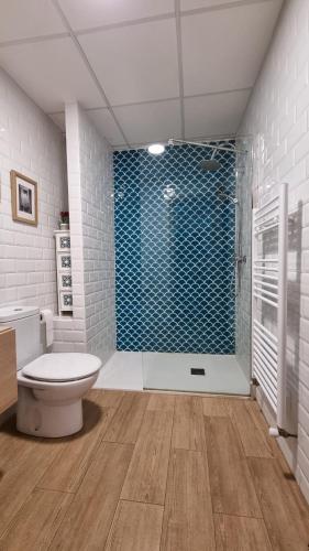 a bathroom with a toilet and a glass shower at Las Casucas del Cartero in Cantabria