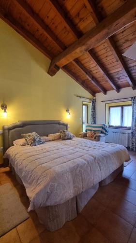 a bedroom with a large bed in a room at Las Casucas del Cartero in Cantabria