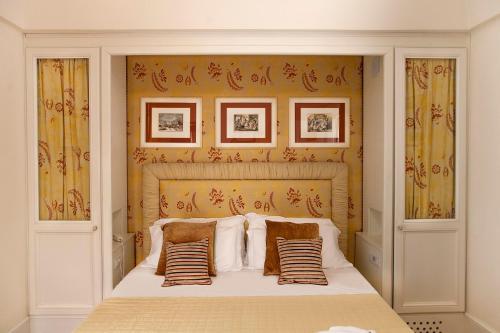 a bedroom with a bed with pillows on it at Relais Villa San Martino in Martina Franca