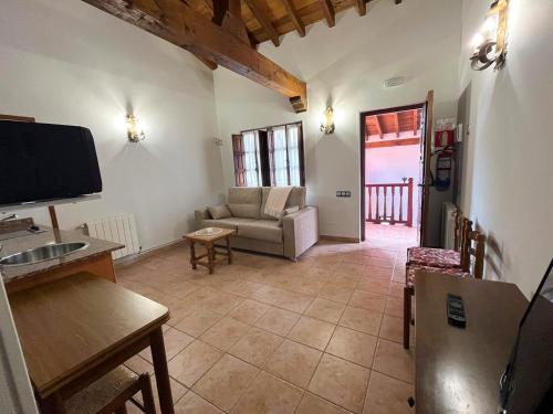 a living room with a couch and a television at Apartamentos Santillana - Mijares 3000 in Mijares