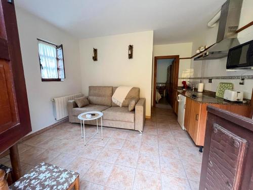 a living room with a couch and a kitchen at Apartamentos Santillana - Mijares 3000 in Mijares