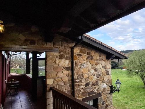 an outside view of a stone building with a porch at Apartamentos Santillana - Mijares 3000 in Mijares