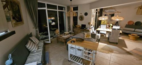 a living room with a couch and a table at Boho Breeze Aheloy in Aheloy