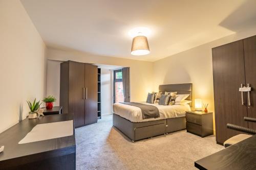 a bedroom with a large bed and a desk at Garden View in York