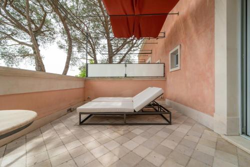 a bench in a room with a window at Relais Villa San Martino in Martina Franca