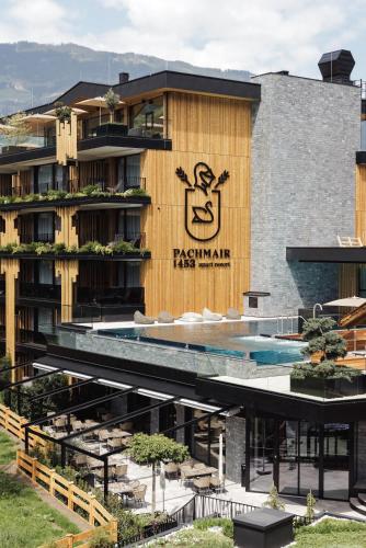 a building with a pool and a sign on it at PACHMAIR 1453 apart resort in Uderns