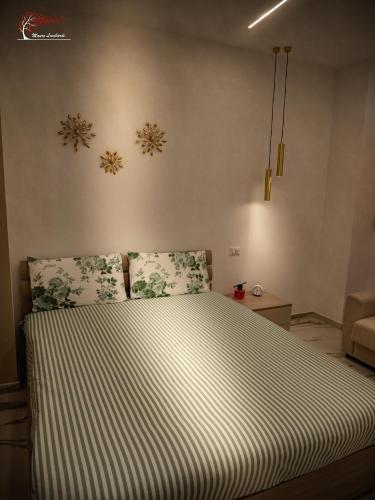 a bed in a bedroom with snowflakes on the wall at Maison della Madonnina in Troia