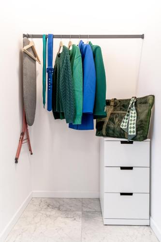 a closet with a rack of clothes and a drawer at H11 Aparthotel in Kraków