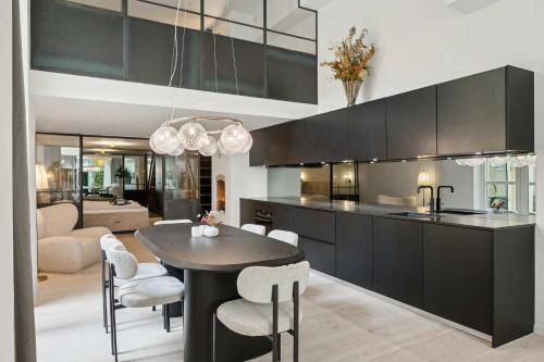 a kitchen and living room with a table and chairs at Luxury Stay by Freetown & Canals in Copenhagen