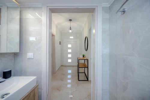 a bathroom with a walk in shower and a sink at House 2BD Private Parking Next to Center in Asprovalta