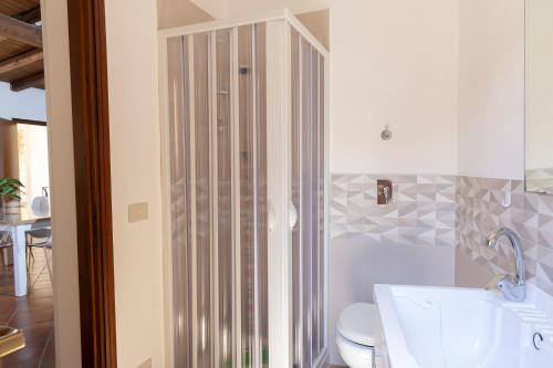 a bathroom with a toilet and a glass shower at La casa di PippiGiu in Marsala