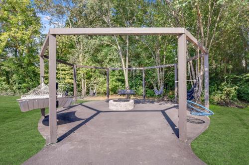 a swing set in a park with a canopy at Stay And Play 18 Guest Family Fun - Pickleball Court in Sevierville