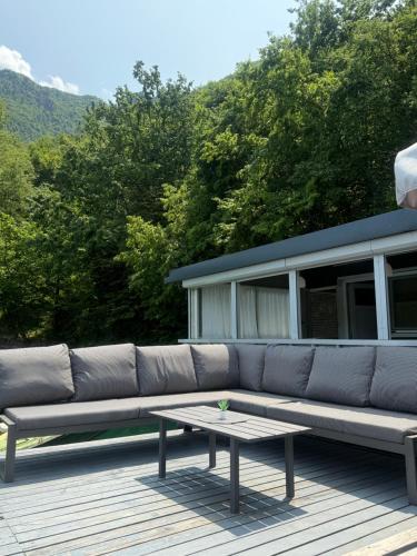 a large couch sitting on a deck with a table at Splav ANDJELA Perucac in Perućac