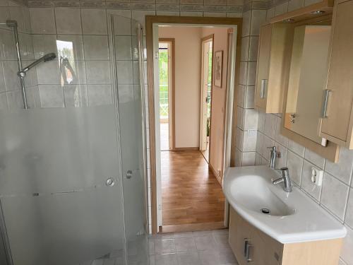 a bathroom with a shower and a sink at Holiday Home 36A BÅSTAD in Båstad