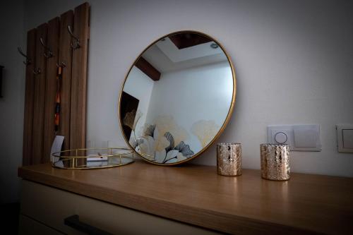 a mirror sitting on top of a wooden table at Penthouse Secret Rose with pool, jacuzzi, sauna, private garage, entry with pin 0-24h in Slavonski Brod