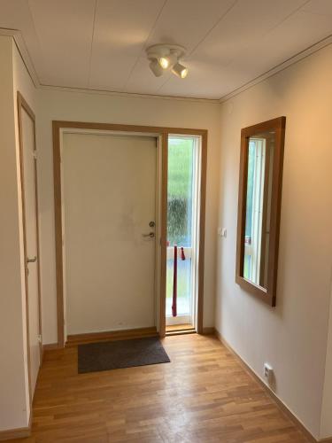 an empty room with a door and a mirror at Holiday Home 36A BÅSTAD in Båstad
