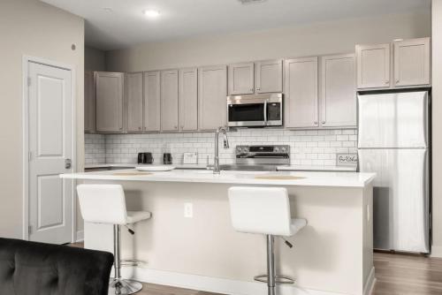 a kitchen with white cabinets and white appliances at Spacious Whitestown Getaway in Whitestown