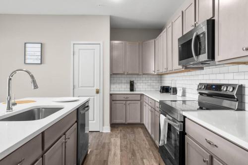 a kitchen with white appliances and wooden cabinets at Spacious Whitestown Getaway in Whitestown