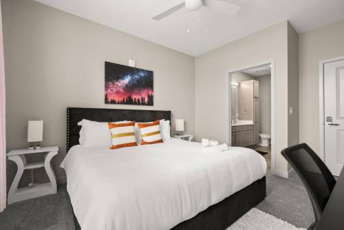 a bedroom with a large white bed with orange pillows at Spacious Whitestown Getaway in Whitestown