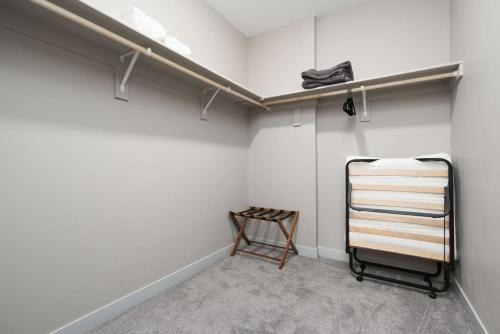 a walk in closet with white walls and a shelf at Spacious Whitestown Getaway in Whitestown