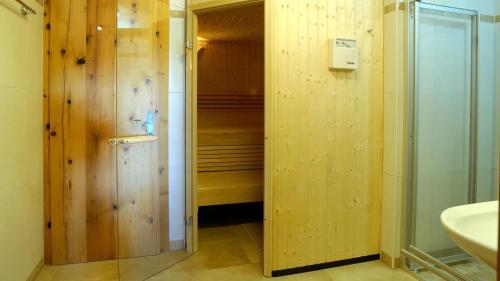 a bathroom with a walk in shower next to a sink at Skihütte Silberleiten, 14 Personen in Krimml