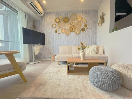 a living room with a couch and a table at Ocean Front! New Built Apartment! SOU Resort YAKA in Kin
