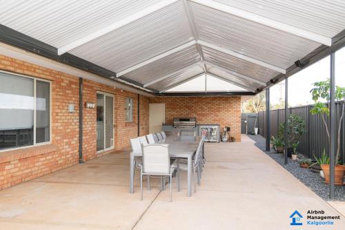 a patio with awning and a table and chairs at Luxury Desert Paradise in Kalgoorlie
