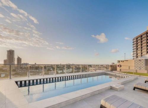a swimming pool on the roof of a building at Stylish Family 1BR with Cozy Bunks and Games for 5 in Sydney