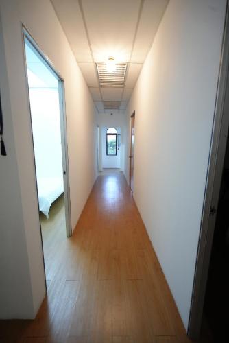 a hallway of an empty room with a door and wood floors at Aimelia guest house in Petaling Jaya