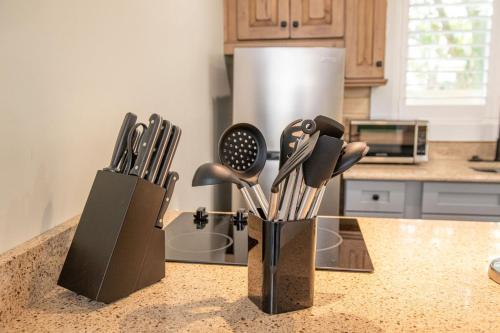 a kitchen counter with some knives in holders on it at King Bed-Step to Madeira Beach-Heated Pool-Private in St Pete Beach