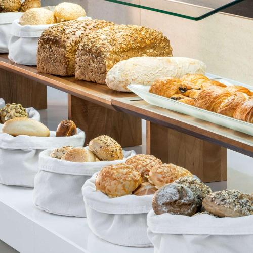 a display of different types of breads and pastries at NH Collection Berlin Mitte Friedrichstrasse in Berlin