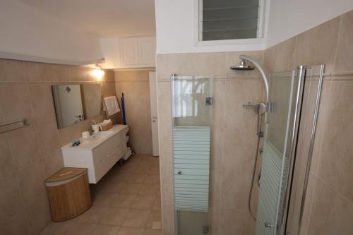 a bathroom with a shower and a sink at Vacation rental in Netanya