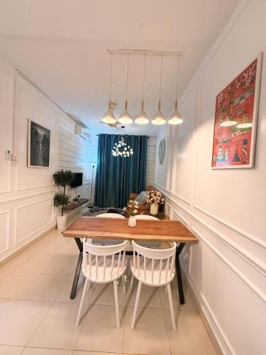 a dining room with a wooden table and chairs at DRIFF Homestay 3bedroom with aircond 50m to Night Market Wakaf Che Yeh in Kota Bharu