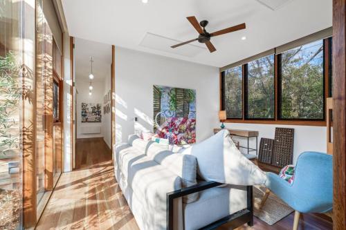 a living room with a couch and a ceiling fan at Hygge by the Ocean - Aireys Inlet in Aireys Inlet