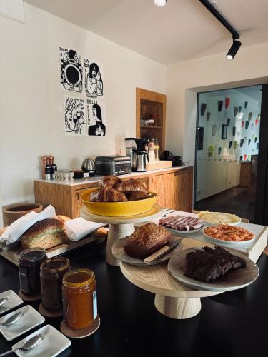 a table with several different types of breads and pastries at Le Relais de Saint de Ser in Puyloubier