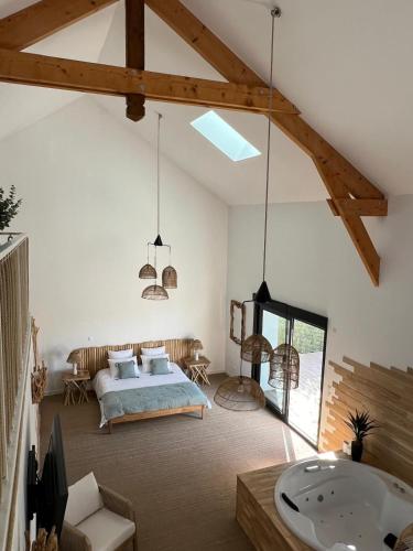 une chambre avec un lit et une baignoire dans une pièce dans l'établissement La Suite Corse avec Spa, à Lavilletertre